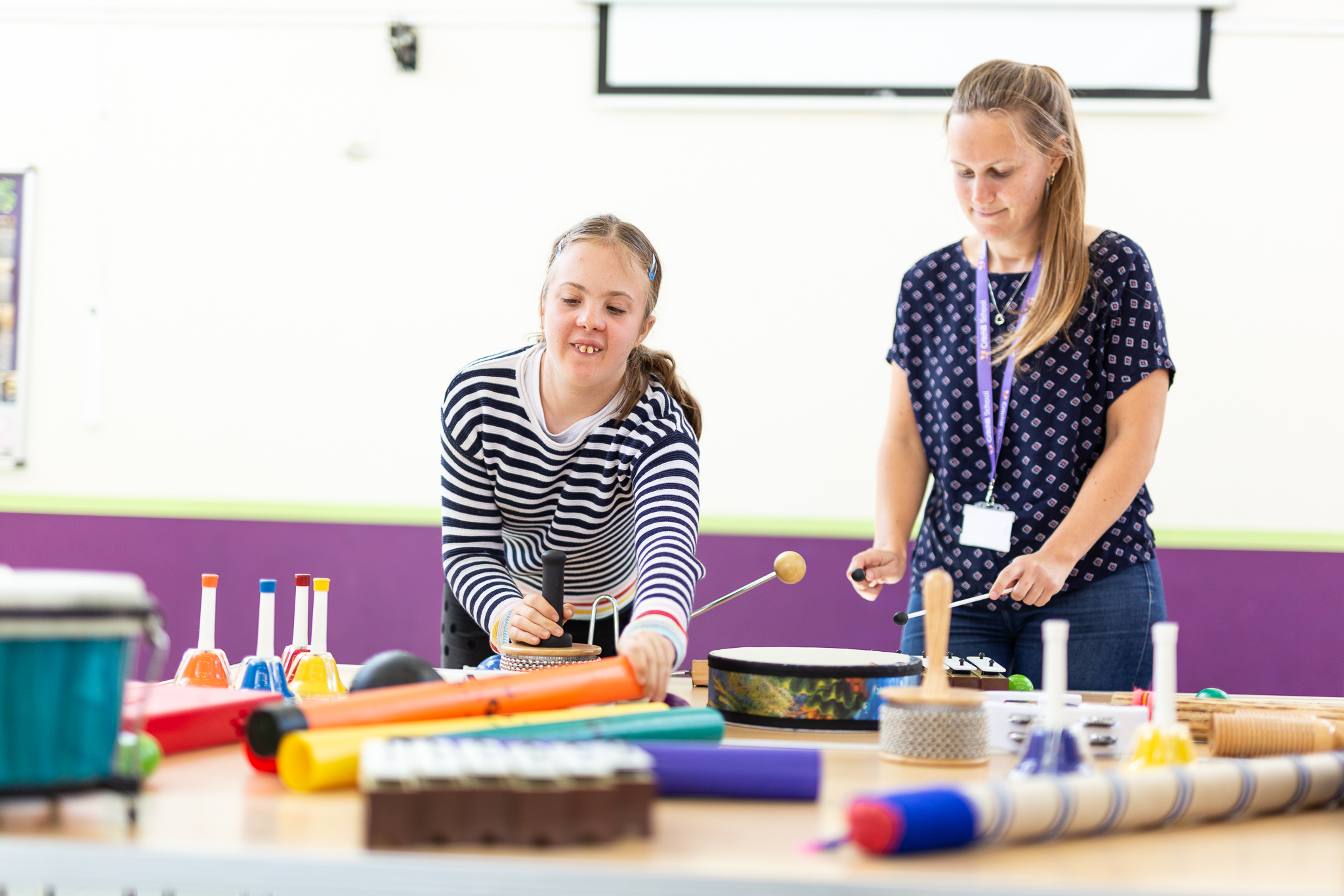 younger performer making music with instruments with tutor