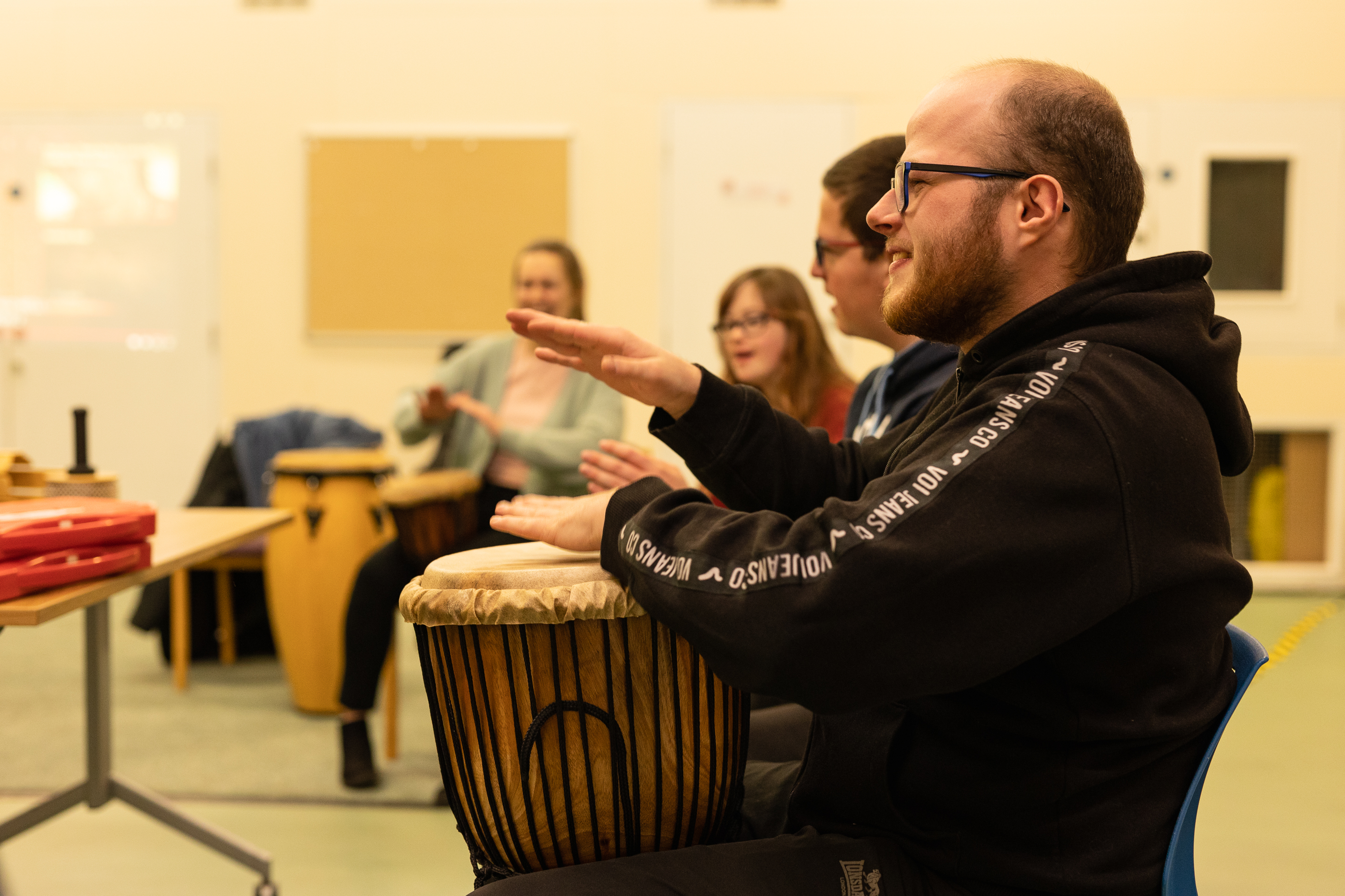 Group of performers banging the drums